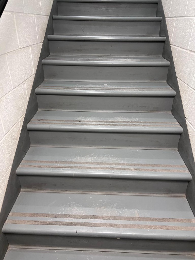 Commercial interior stair before service — no people. Reference photo 1 of 1.