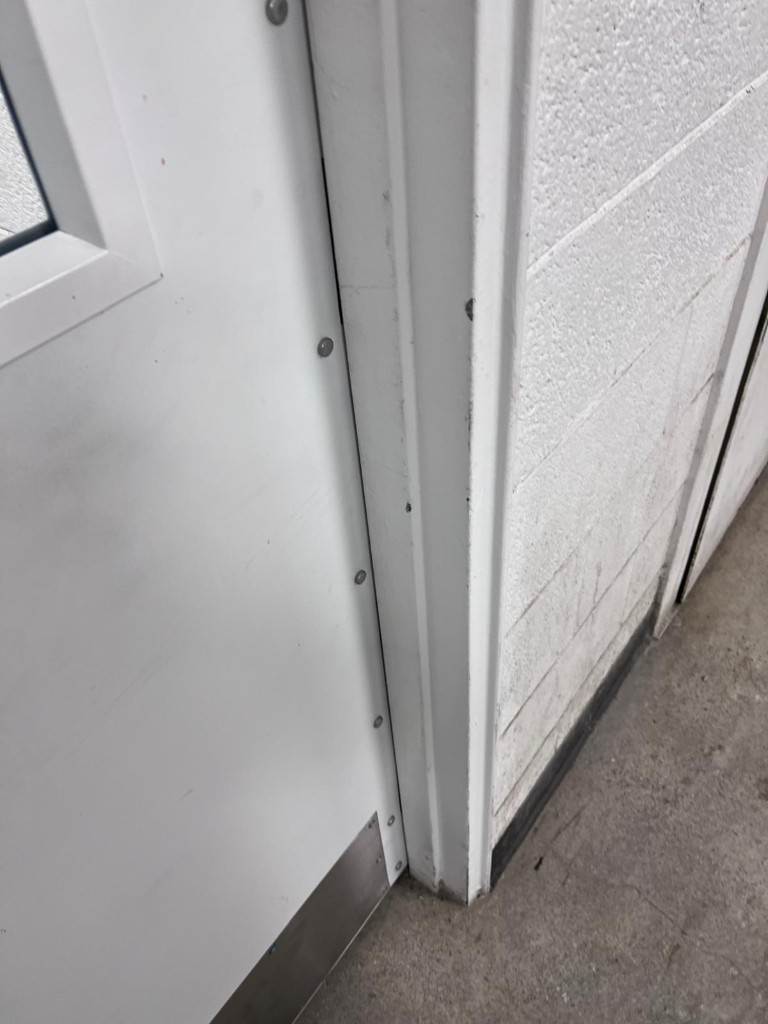 Commercial door frame and surround after service — no people. Reference photo 1 of 1.