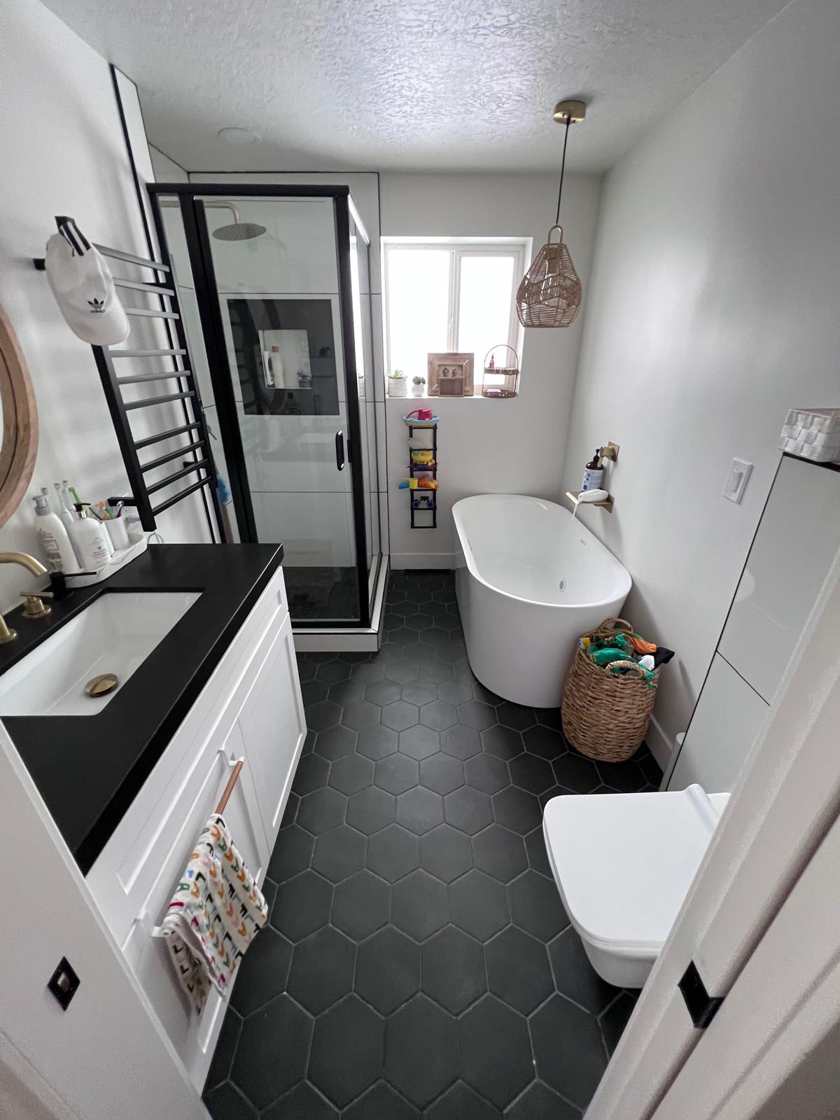 Residential bathroom after deep cleaning. Clear floor, clean vanity, shower, and bathtub.