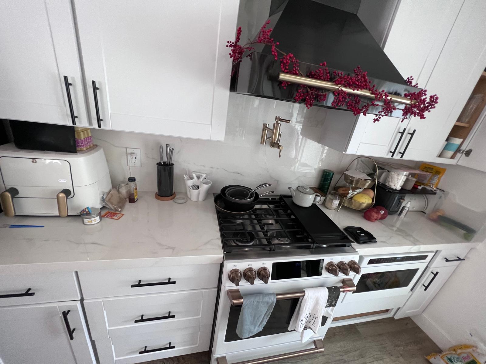 Residential kitchen after cleaning with clearer counters and cooking area.